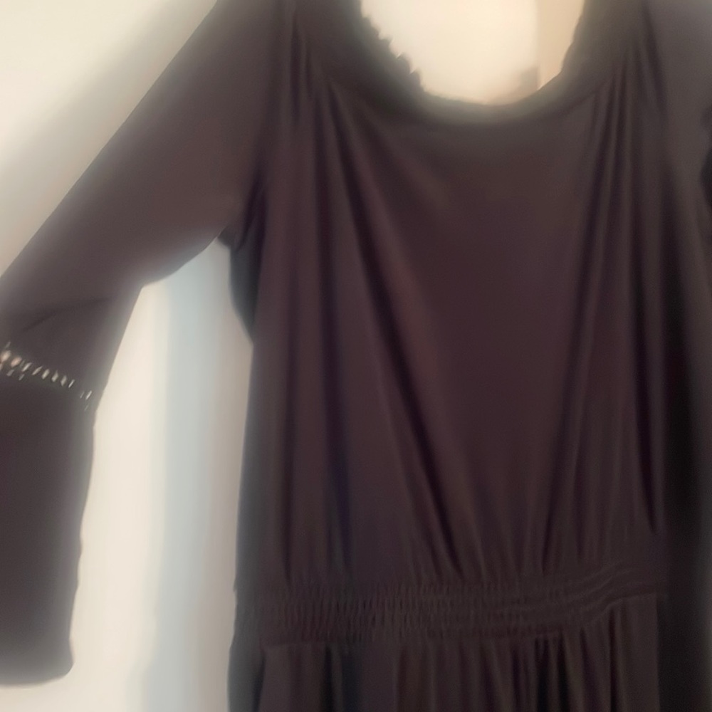 Black one piece suit. Elastic waistband Ed, cropped. Polyester and spandex